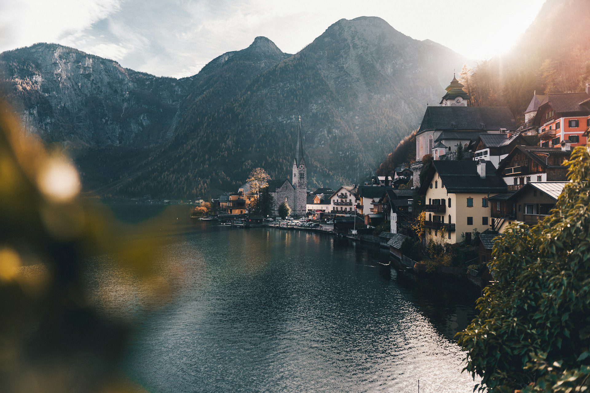 Áustria. Foto de cidade ao lado de um rio com grande montanha ao fundo